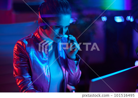stylish woman with headset using laptop 101516495