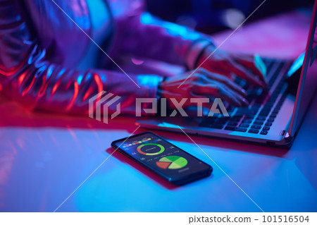 Modern woman using smartphone and exploring graphs Modern woman using smartphone and exploring graphs 101516504