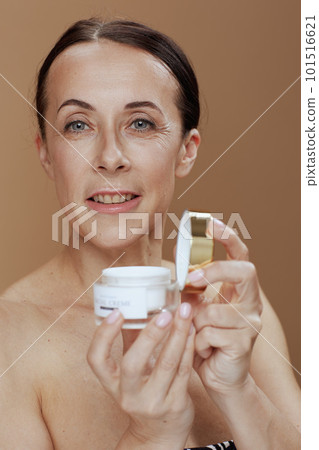 Portrait of modern 40 years old woman isolated on beige Portrait of modern 40 years old woman isolated on beige 101516621