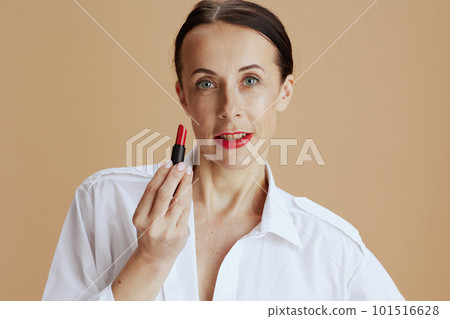 modern 40 years old woman in white shirt isolated on beige modern 40 years old woman in white shirt isolated on beige 101516628