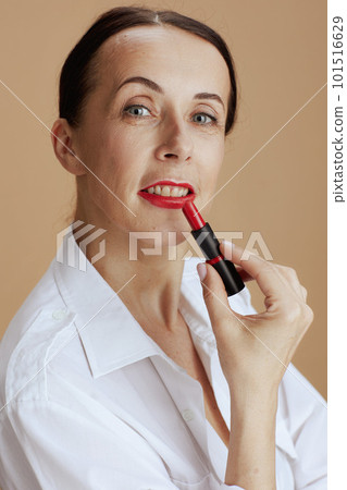 40 years old woman in shirt isolated on beige background 40 years old woman in shirt isolated on beige background 101516629