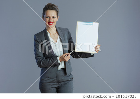 happy elegant business owner woman isolated on grey happy elegant business owner woman isolated on grey 101517025