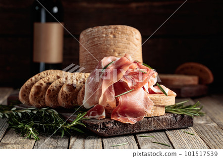 Prosciutto with bread and rosemary. Prosciutto with bread and rosemary. 101517539