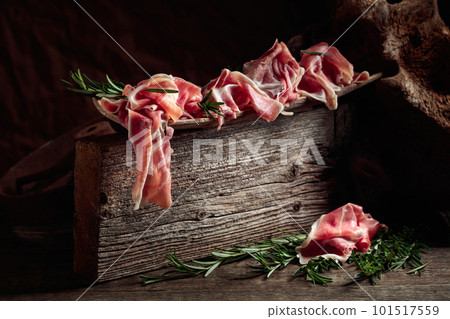 Italian prosciutto crudo or Spanish jamon with rosemary. 101517559