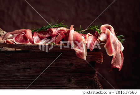 Italian prosciutto crudo or Spanish jamon with rosemary. Italian prosciutto crudo or Spanish jamon with rosemary. 101517560