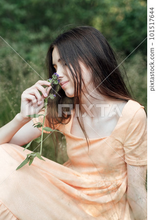 Ways To Unplug From Technology and Be Present. Unplugging from Technology and Living a More Mindful Life. Outdoor portrait of young woman enjoying nature 101517644