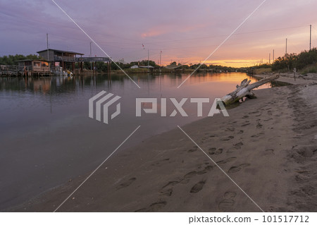 Amazing view of fishing huts at sunset near Comacchio Amazing view of fishing huts at sunset near Comacchio 101517712