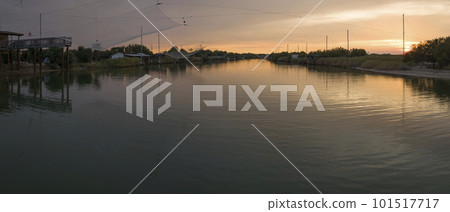 Wonderful view of fishing huts at sunset near Ravenna Wonderful view of fishing huts at sunset near Ravenna 101517717