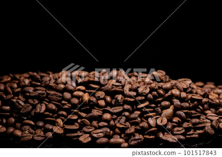 A pile of coffee beans on a black background A pile of coffee beans on a black background 101517843