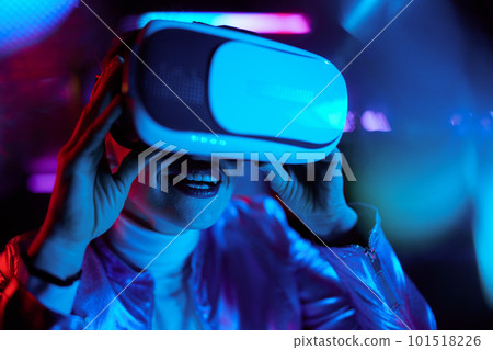 smiling modern 40 years old woman testing out virtual reality 101518226
