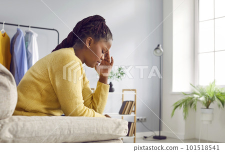 Unhappy depressed young woman touching her head feeling despair Unhappy depressed young woman touching her head feeling despair 101518541