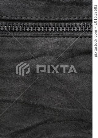 Crumpled black suede textured vertical background with black metal zip Crumpled black suede textured vertical background with black metal zip 101518692