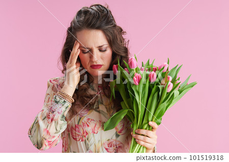 stressed young woman with long wavy brunette hair on pink stressed young woman with long wavy brunette hair on pink 101519318