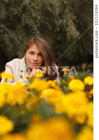 Pretty woman in yellow flowers outdoor 101519364