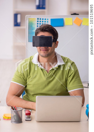 Young male designer enjoying virtual glasses at home 101519695