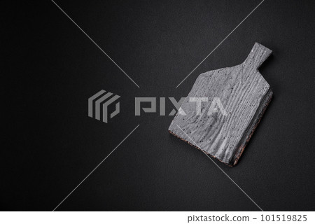 Empty wooden cutting board on dark concrete background Empty wooden cutting board on dark concrete background 101519825