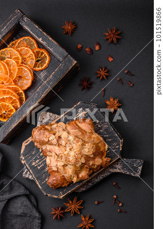 Fresh crispy croissant with almond chips and chocolate filling Fresh crispy croissant with almond chips and chocolate filling 101519866