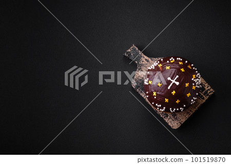 Freshly baked Easter cake or panettone with chocolate coating Freshly baked Easter cake or panettone with chocolate coating 101519870
