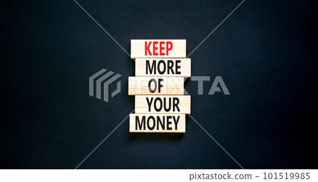 Keep more of your money symbol. Concept words Keep more of your money on wooden block. Beautiful black table black background. Business keep more of your money concept. Copy space. 101519985