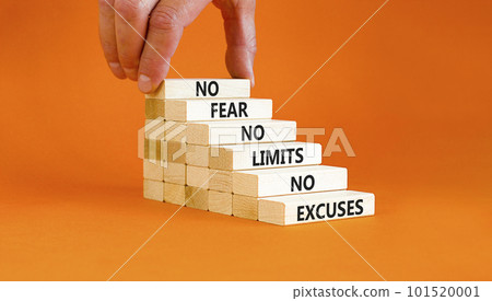 No fear limits excuses symbol. Concept words No fear no limits no excuses on wooden blocks. Beautiful orange background. Businessman hand. Business not fear limits excuses concept. Copy space. 101520001