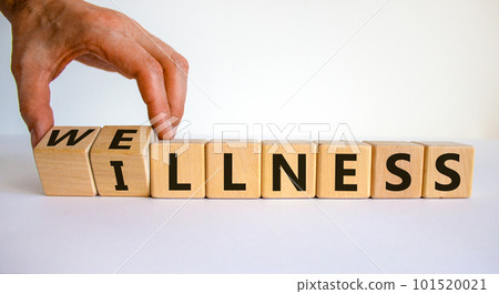 Wellness or illness. Male hand flips wooden cubes and changes the inscription 'illness' to 'wellness' or vice versa. Beautiful white background, copy space. Lifestyle concept. 101520021