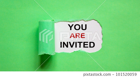 The text 'you are invited' appearing behind torn green paper. 101520059