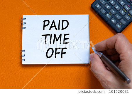 Paid time off symbol. Businessman writing words 'Paid time off' on white note. Beautiful orange background. Business, paid time off concept. Copy space. Paid time off symbol. Businessman writing words 'Paid time off' on white note. Beautiful orange background. Business, paid time off concept. Copy space. 101520081