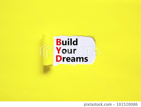 BYD build your dreams symbol. Concept words BYD build your dreams on white paper on a beautiful yellow background. Business and BYD build your dreams concept. Copy space. 101520086