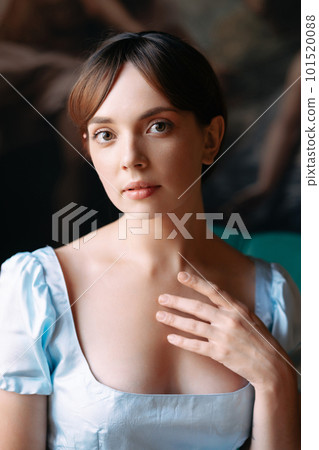Portrait of a young beautiful girl in a blue Regency style dress Portrait of a young beautiful girl in a blue Regency style dress 101520088