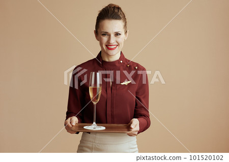 happy stylish flight attendant woman against beige background 101520102