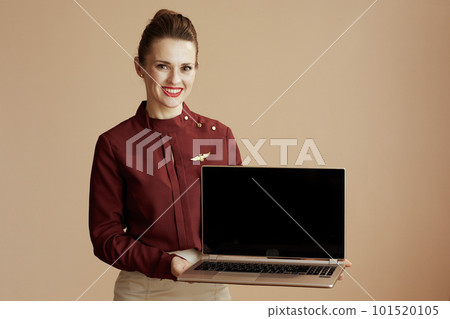 happy air hostess woman on beige showing laptop blank screen happy air hostess woman on beige showing laptop blank screen 101520105