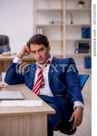 Young male employee and too much work in the office Young male employee and too much work in the office 101520108