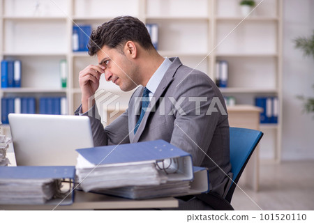 Young male employee working in the office Young male employee working in the office 101520110