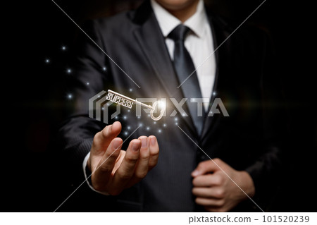 Businessman holding the key to success . Businessman holding the key to success . 101520239