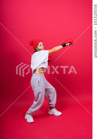 Cute little girl in boxing gloves on red background studio Cute little girl in boxing gloves on red background studio 101520558