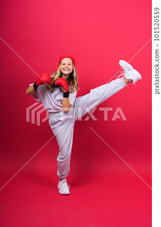 Cute little girl in boxing gloves on red background studio 101520559