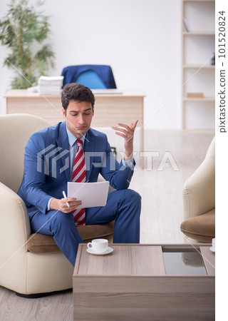 Young male employee sitting in the office 101520824