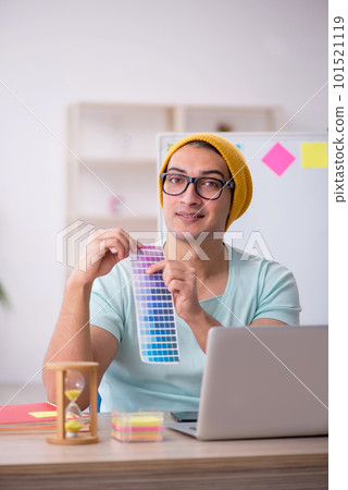 Young male designer sitting in the office 101521119