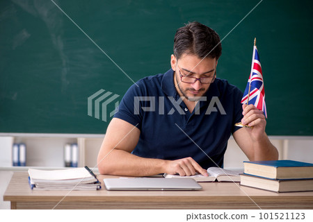 Male English language teacher in front of green board Male English language teacher in front of green board 101521123