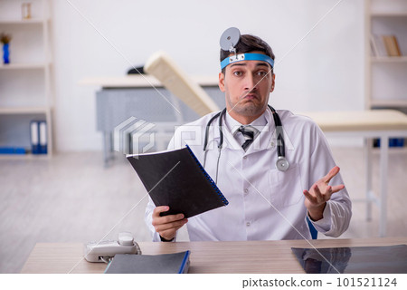 Young male doctor otolaryngologist working in the clinic Young male doctor otolaryngologist working in the clinic 101521124