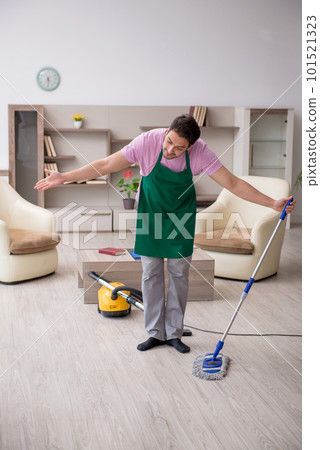 Young male contractor cleaning the house 101521323