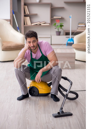 Young male contractor cleaning the house Young male contractor cleaning the house 101521331