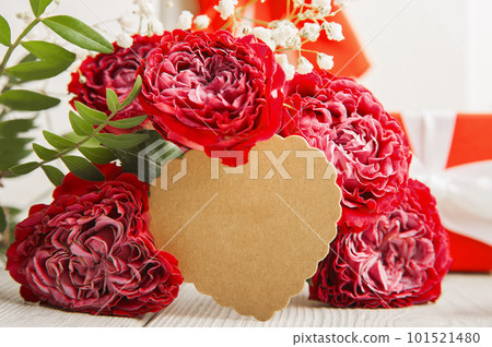 Greeting card with tag and red roses close-up. International Women's Day, Mother's Day, March 8 concept 101521480