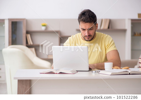 Young male student studying at home 101522286