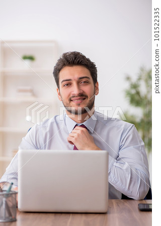 Young male employee working in the office Young male employee working in the office 101522335