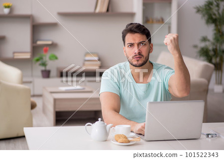 Young male freelancer working from home 101522343
