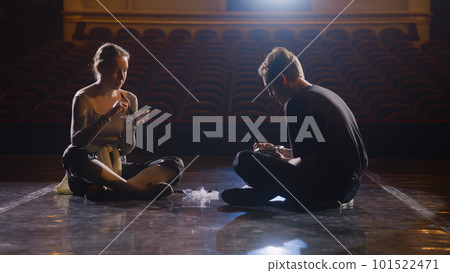 Couple of tired ballet dancers rest after rehearsal Couple of tired ballet dancers rest after rehearsal 101522471
