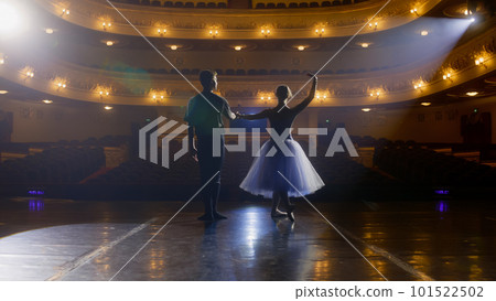 Ballet dancers bow down in front of rows of seats Ballet dancers bow down in front of rows of seats 101522502