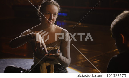 Couple of ballet dancers sit on stage and talk 101522575