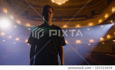 Ballet male dancer stands on stage and looks at camera Ballet male dancer stands on stage and looks at camera 101522659